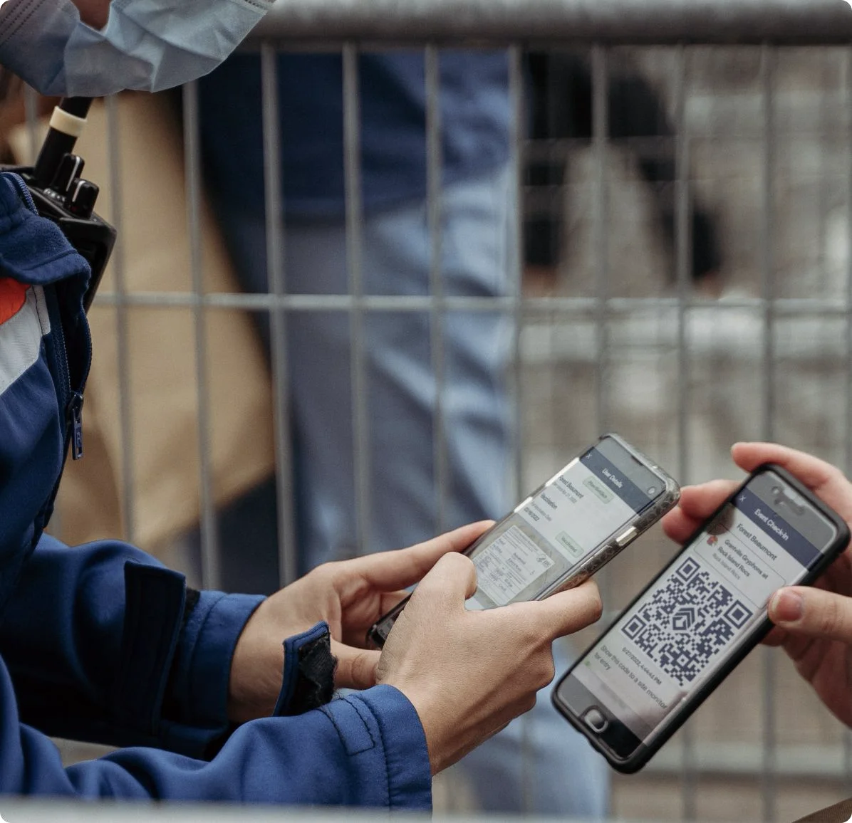 A site monitor scanning a guest’s QR pass at a venue entrance